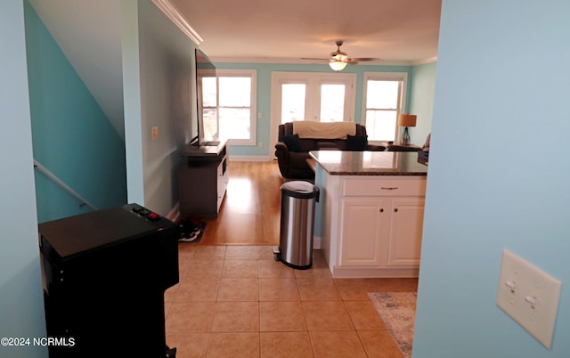 kitchen featuring ceiling fan, light hardwood / wood-style flooring, crown molding, and white cabinetry