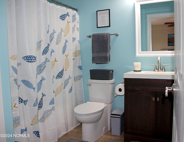 bathroom with tile patterned flooring, a shower with curtain, vanity, and toilet