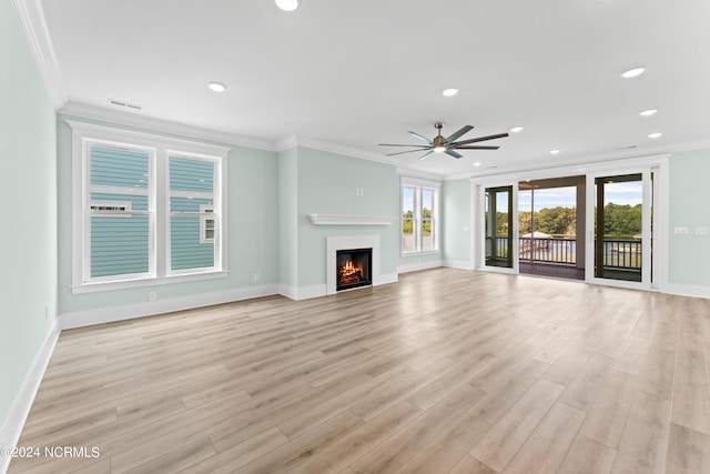 unfurnished living room featuring ceiling fan, light wood-type flooring, and crown molding