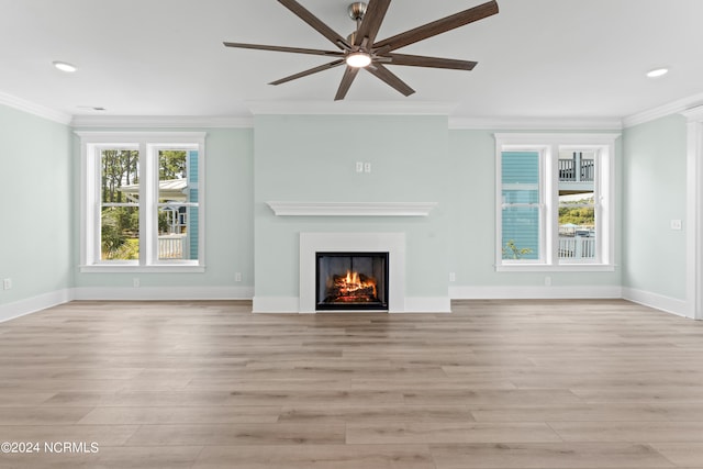 unfurnished living room featuring ceiling fan, crown molding, and light hardwood / wood-style flooring