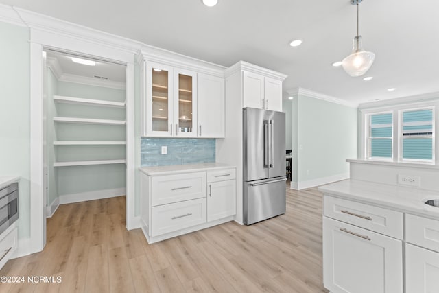 kitchen featuring backsplash, high end refrigerator, light hardwood / wood-style flooring, and white cabinets