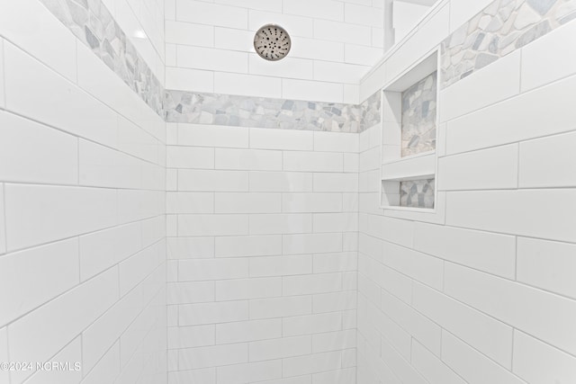 bathroom with a tile shower