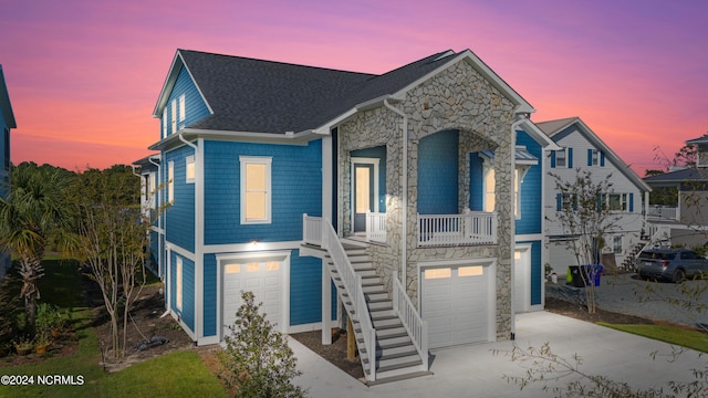 view of front of house with a porch and a garage