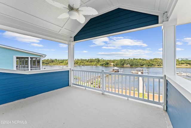 balcony with ceiling fan and a water view