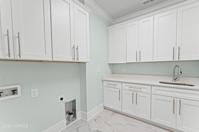 washroom featuring cabinets, sink, crown molding, hookup for a washing machine, and hookup for an electric dryer