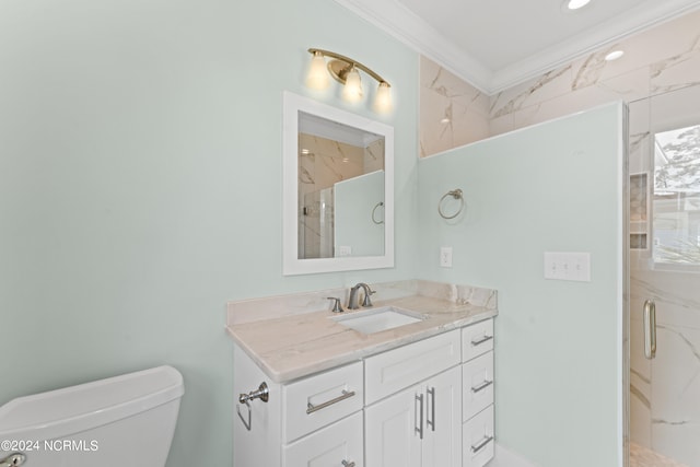 bathroom featuring vanity, toilet, a shower with door, and crown molding