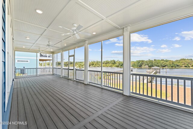 wooden deck featuring a water view and ceiling fan