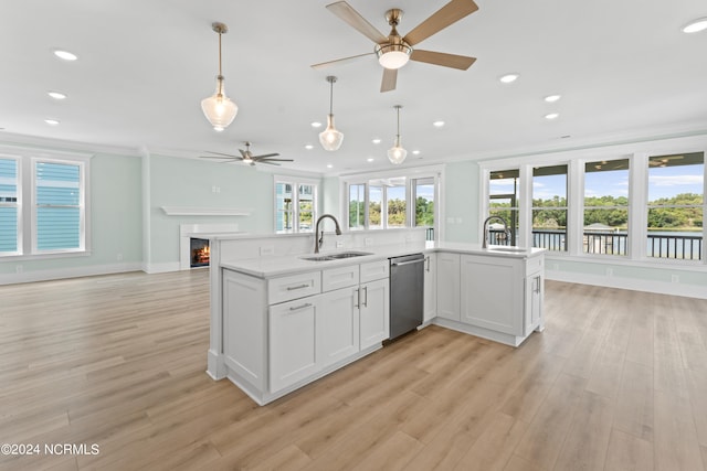 kitchen featuring dishwasher, white cabinets, sink, crown molding, and light hardwood / wood-style flooring