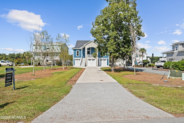 view of front of house with a front yard and a garage