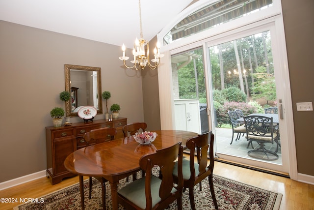 dining area with a chandelier, light wood-type flooring, and baseboards