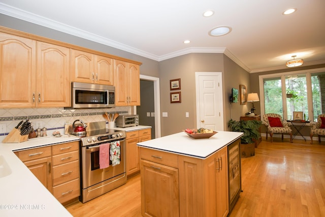 kitchen featuring stainless steel appliances, ornamental molding, light wood-type flooring, and light countertops