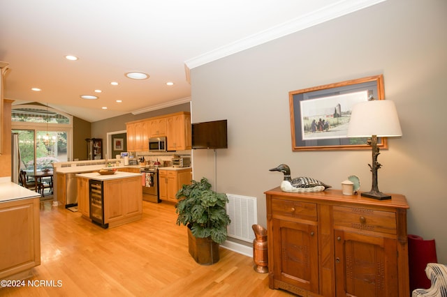 kitchen featuring a center island, light countertops, visible vents, appliances with stainless steel finishes, and light wood-type flooring