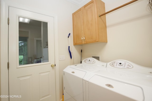 washroom with cabinet space and washer and clothes dryer