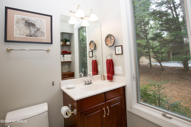 half bathroom with toilet and vanity