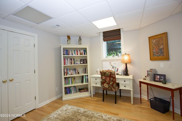 office featuring a drop ceiling, wood finished floors, visible vents, and baseboards