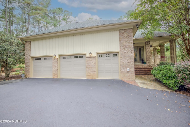 exterior space featuring aphalt driveway and covered porch