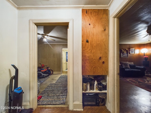 hall featuring wood-type flooring and wood walls