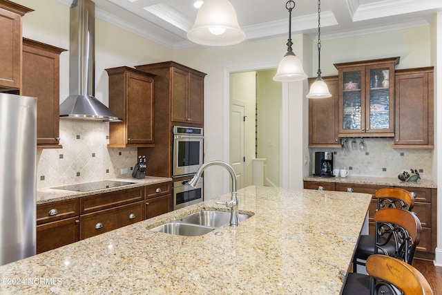 kitchen with light stone countertops, sink, stainless steel appliances, wall chimney range hood, and tasteful backsplash