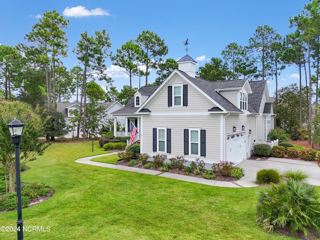 view of front of property featuring a front yard and a garage