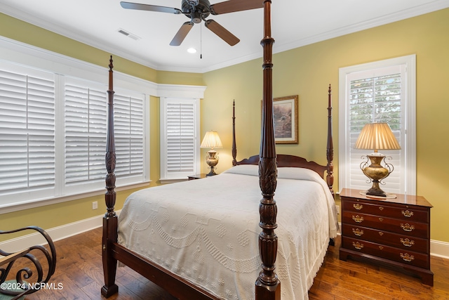 bedroom with dark hardwood / wood-style flooring, ceiling fan, and crown molding