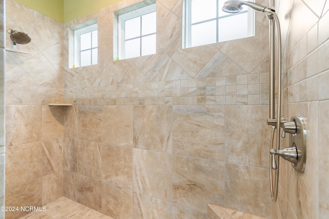 bathroom with a tile shower