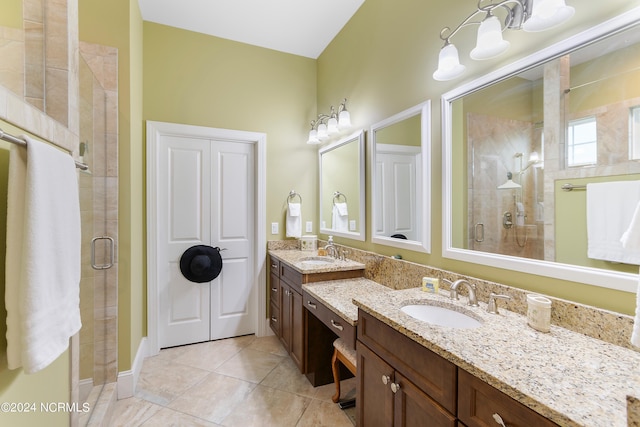 bathroom with tile patterned flooring, vanity, and an enclosed shower