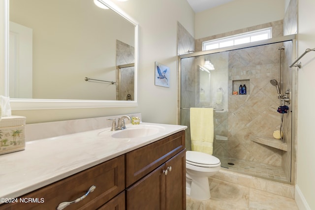 bathroom featuring vanity, an enclosed shower, and toilet