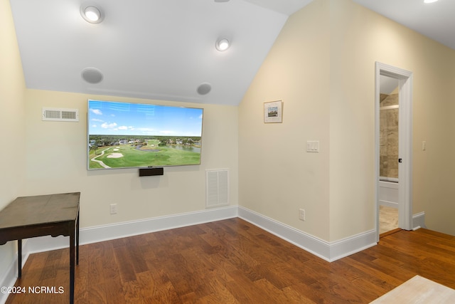 unfurnished living room featuring hardwood / wood-style floors and lofted ceiling