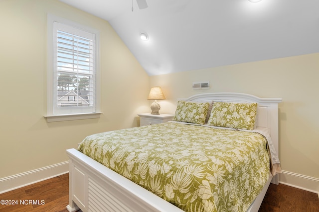 bedroom with vaulted ceiling, ceiling fan, and dark hardwood / wood-style floors