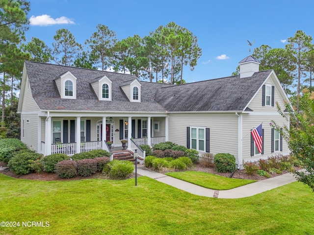 new england style home featuring a porch and a front yard