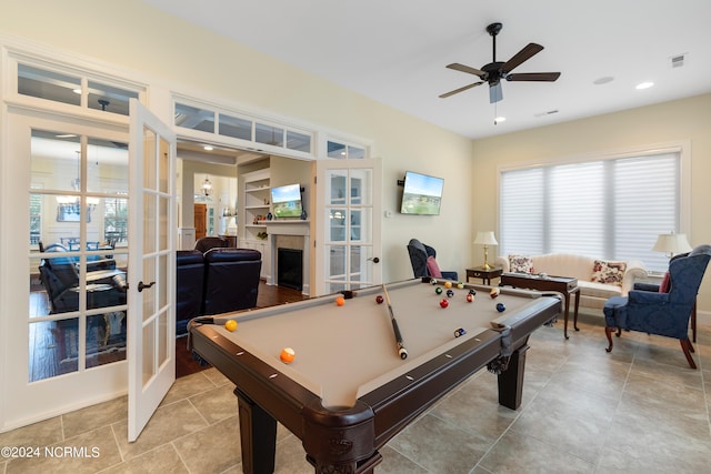 recreation room with ceiling fan, french doors, a healthy amount of sunlight, and billiards