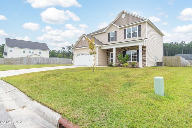 view of front facade featuring a front yard, central air condition unit, and a garage