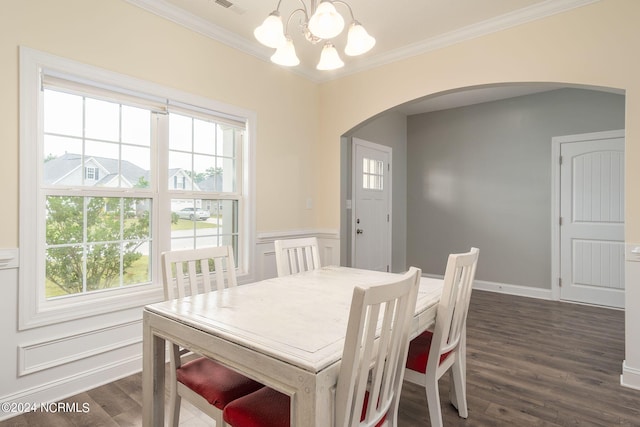 dining space featuring a chandelier, a healthy amount of sunlight, and dark hardwood / wood-style flooring