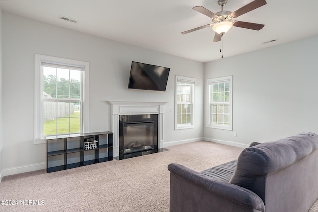 carpeted living room featuring ceiling fan