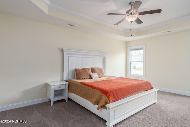 carpeted bedroom featuring crown molding, a tray ceiling, and ceiling fan