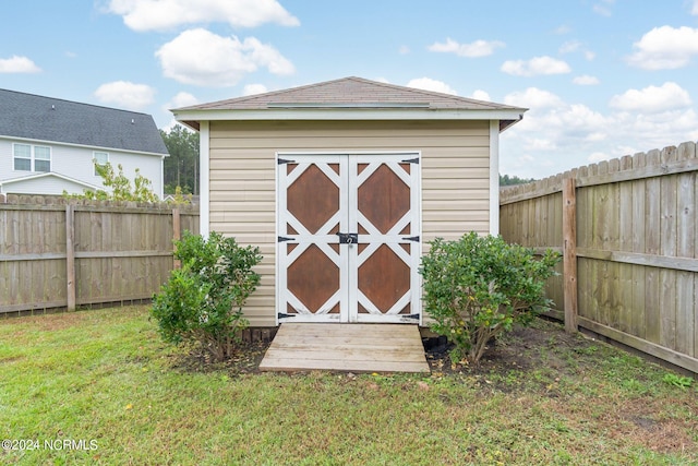 view of outbuilding featuring a yard