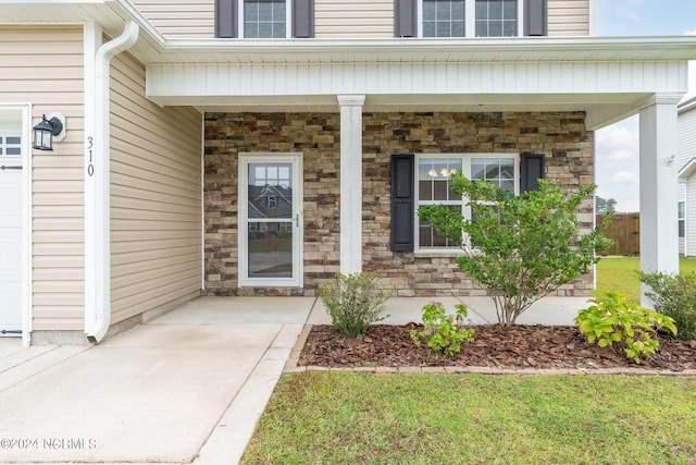 doorway to property with covered porch