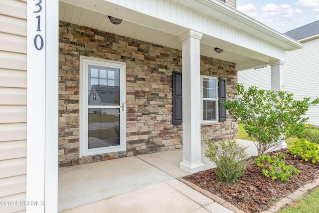 doorway to property featuring covered porch