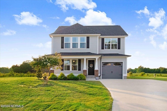 view of front of property featuring a front yard and a garage