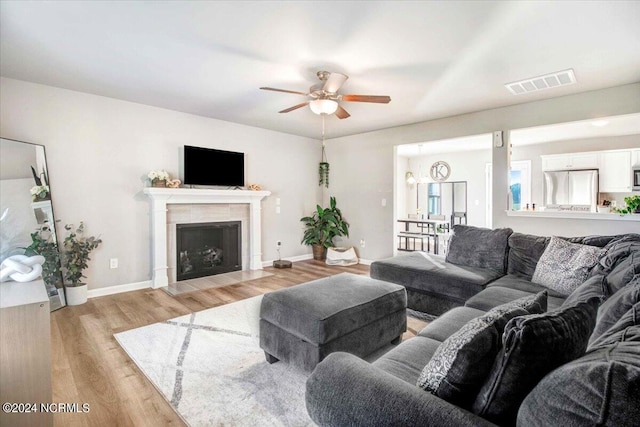 living room featuring light wood-type flooring and ceiling fan