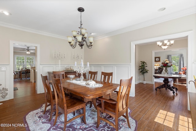 dining space featuring ornamental molding, dark wood-type flooring, and a chandelier