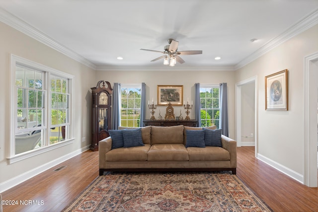 living room featuring ornamental molding, dark hardwood / wood-style floors, and a wealth of natural light