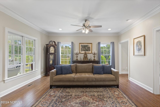 living area featuring dark wood-type flooring, baseboards, ornamental molding, and ceiling fan