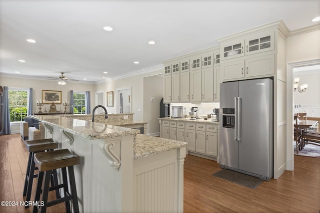 kitchen with crown molding, high end refrigerator, and dark wood-style floors