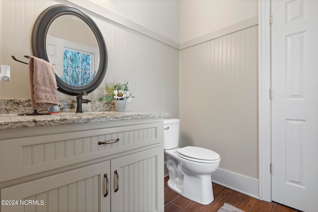 bathroom with vanity, hardwood / wood-style floors, and toilet