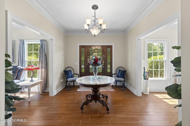dining area with ornamental molding, baseboards, a chandelier, and a healthy amount of sunlight