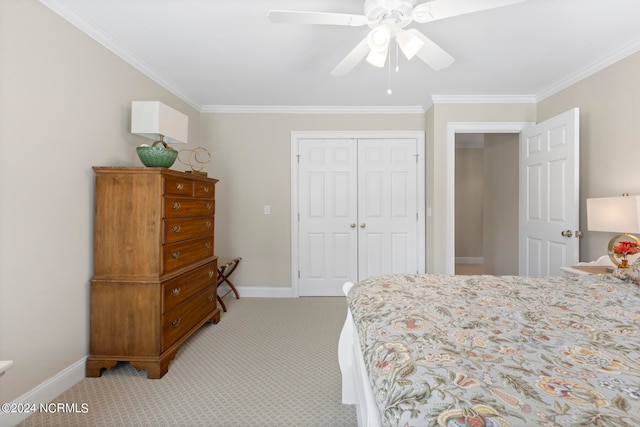 carpeted bedroom featuring crown molding, a closet, and ceiling fan