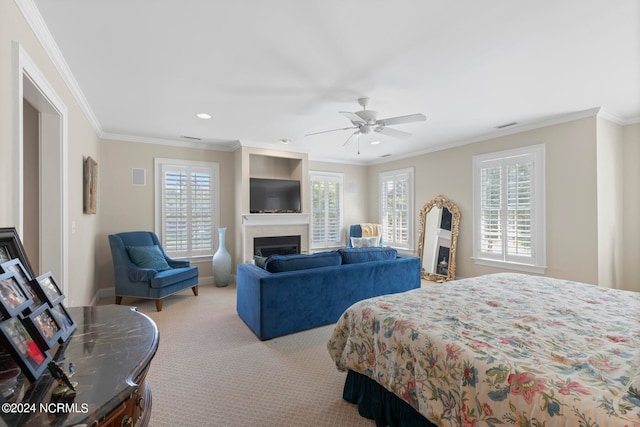 carpeted bedroom with multiple windows, crown molding, and ceiling fan