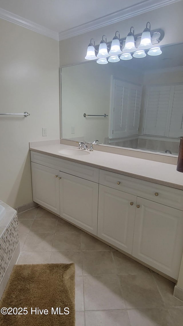 bathroom with tile patterned floors, vanity, ornamental molding, and a relaxing tiled tub