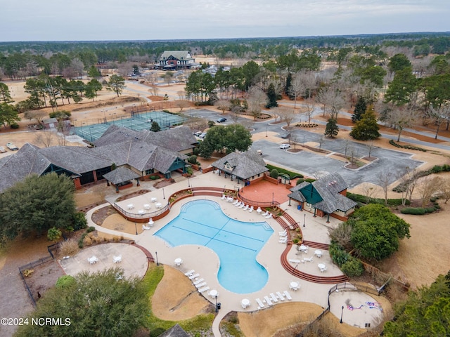 community pool with fence and a patio